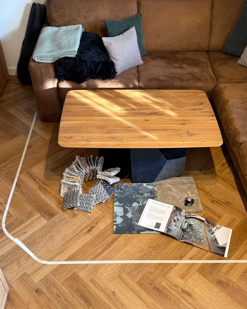 Mit Klebeband markierte Teppichfläche im Wohnzimmer, um Größe, Proportionen und Nutzung vor der Gestaltung sichtbar zu machen.