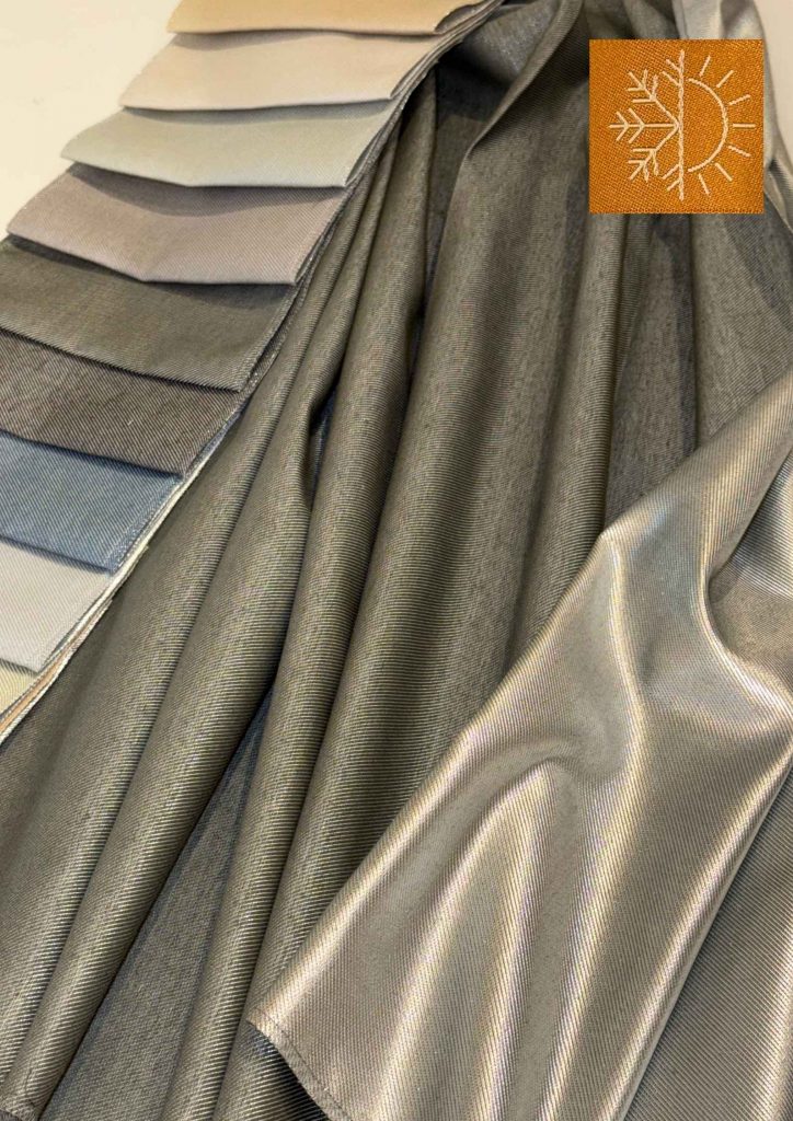 Vorhangstoffe mit reflektierender Rückseite im WerkLaden – das Thermo-Piktogramm zeigt die Wirkung im Sommer und Winter