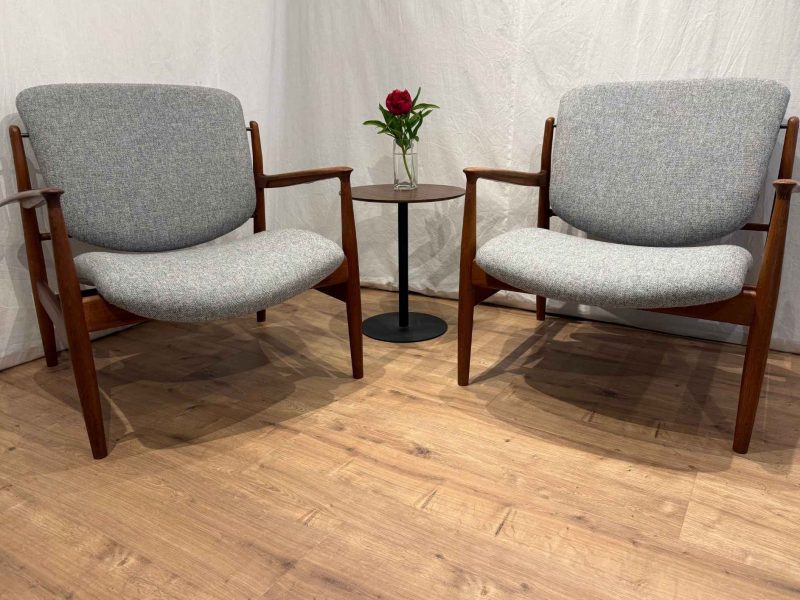 Zwei fertig neu bezogene Finn Juhl 136 Sessel von France & Søn in hellgrauem Wollstoff mit Teakholzgestell, fotografiert in der Werkstatt von Die Raumausstatterin Mauerstetten